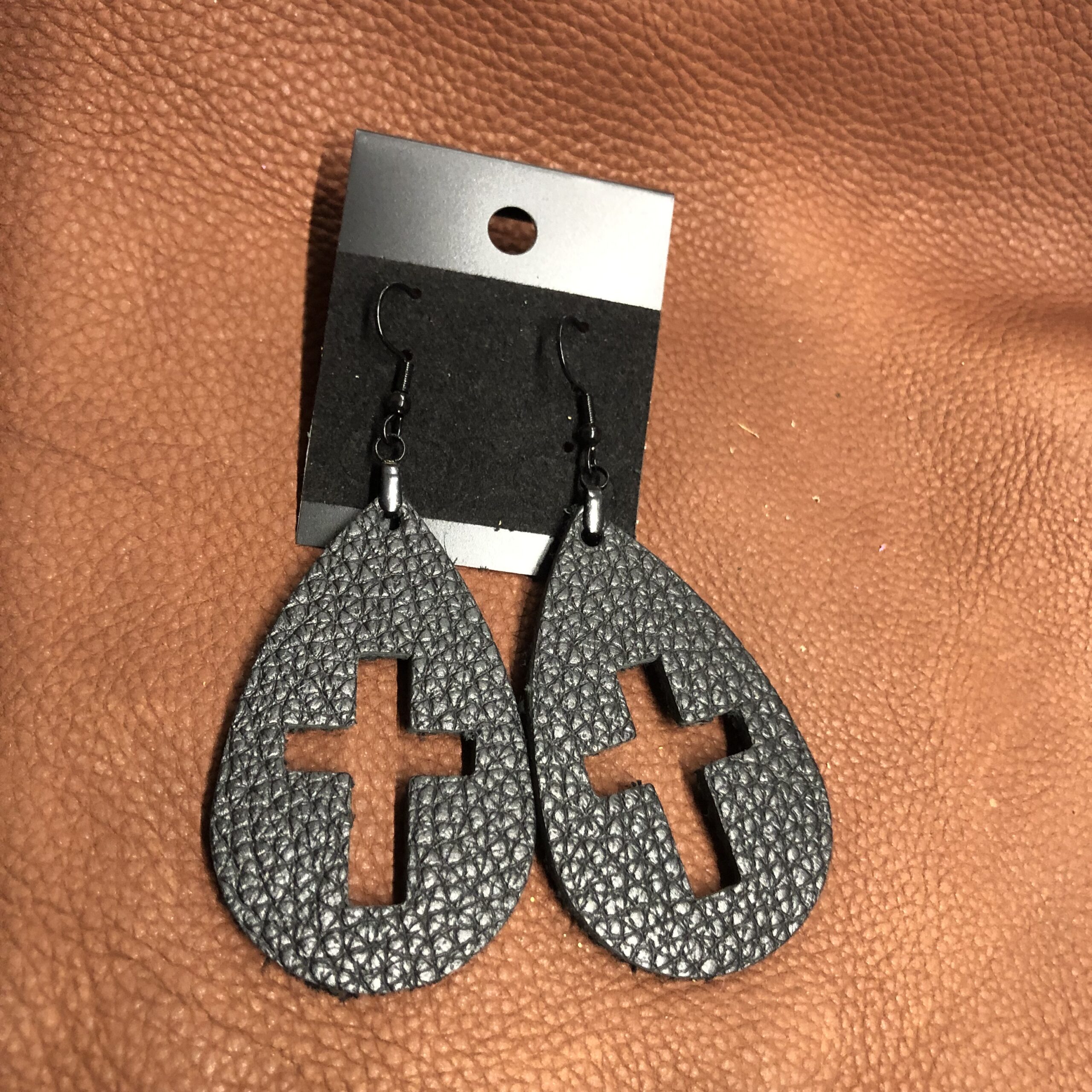 Real Black Pebbled Leather Cross Cutout Teardrop Earrings on Black Ear Wires