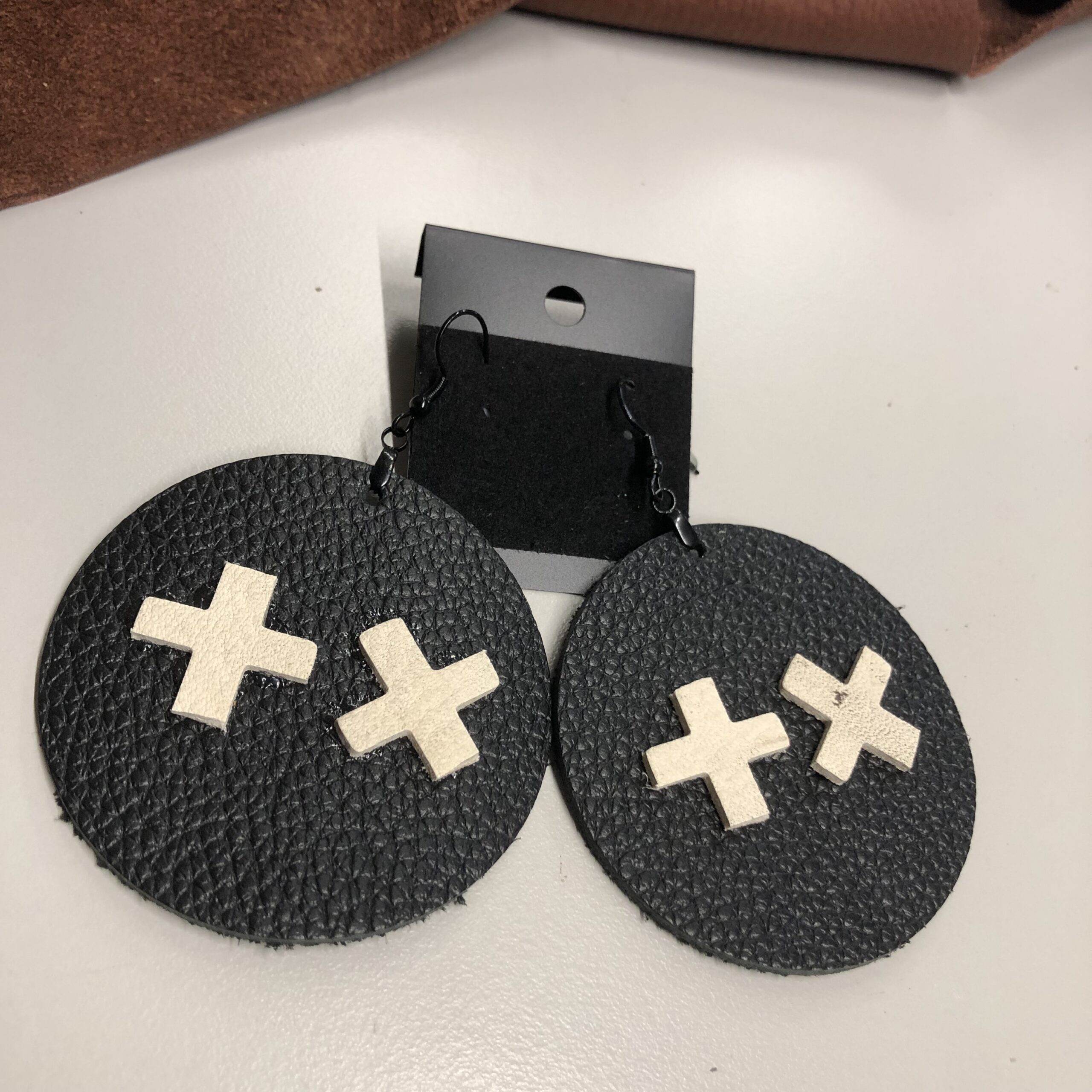 Black Pebbled Leather 2.25inch Circle Earrings with Cross & X on Black Ear Wires