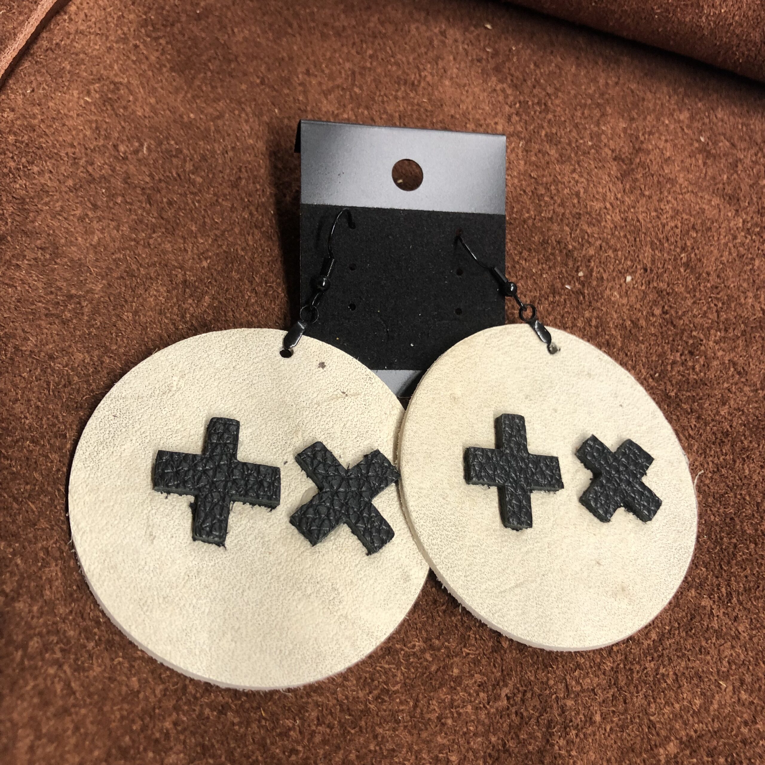 White Cowhide Leather 2.25inch Circle Earrings with Black Pebbled Leather Cross & X on Black Ear Wires