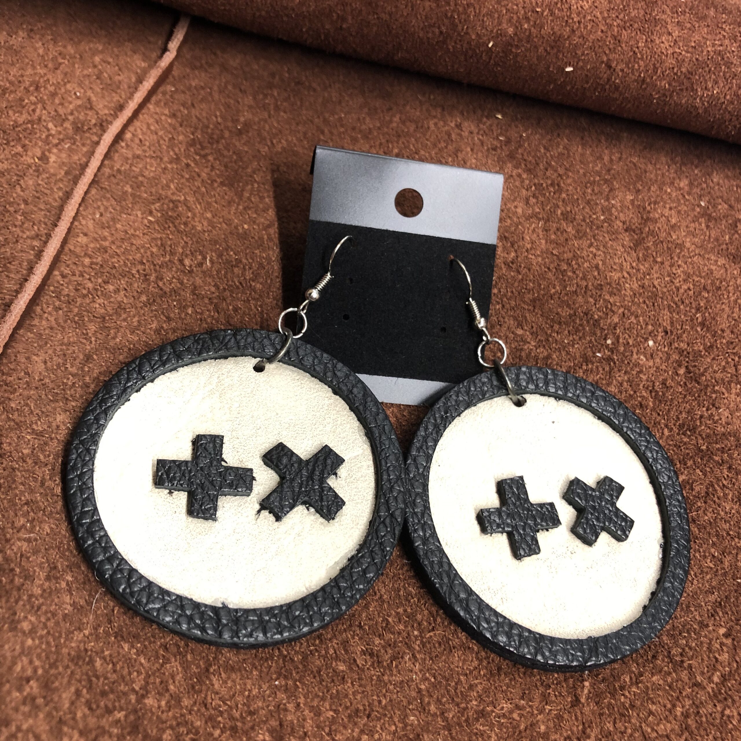 White Cowhide Leather 2.25inch Circle Earrings with Black Pebbled Leather Frame, Cross, & X on Gunmetal Ear Wires