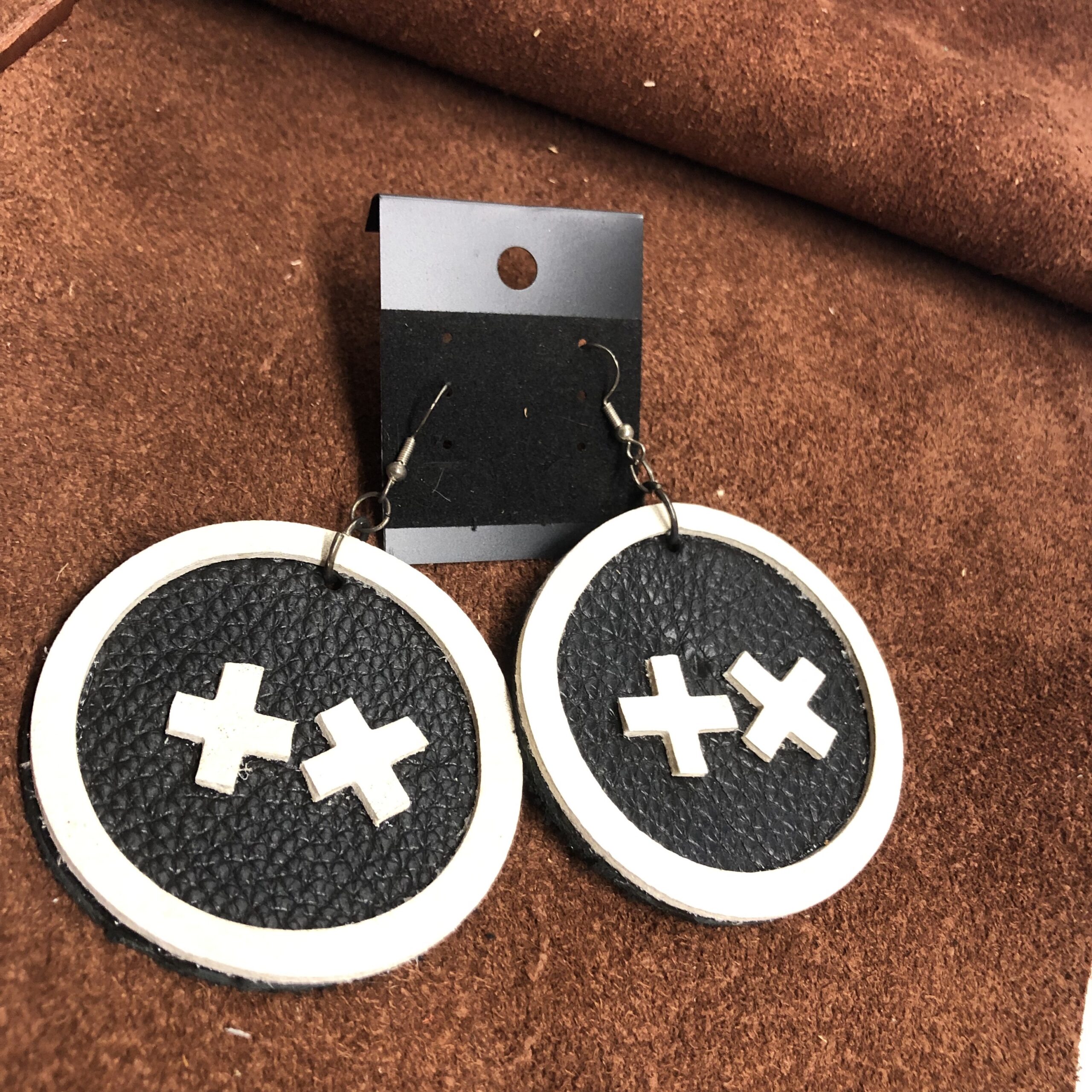 Black Pebbled Leather 2.25inch Circle Earrings with White Cowhide Frame, Cross, & X on Gunmetal Ear Wires